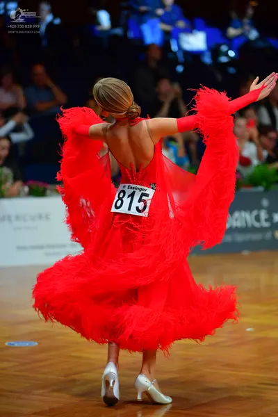 Dancesport competitor #815: Female dancer: red Latin dress with feathery sleeves and skirt, backless style, 