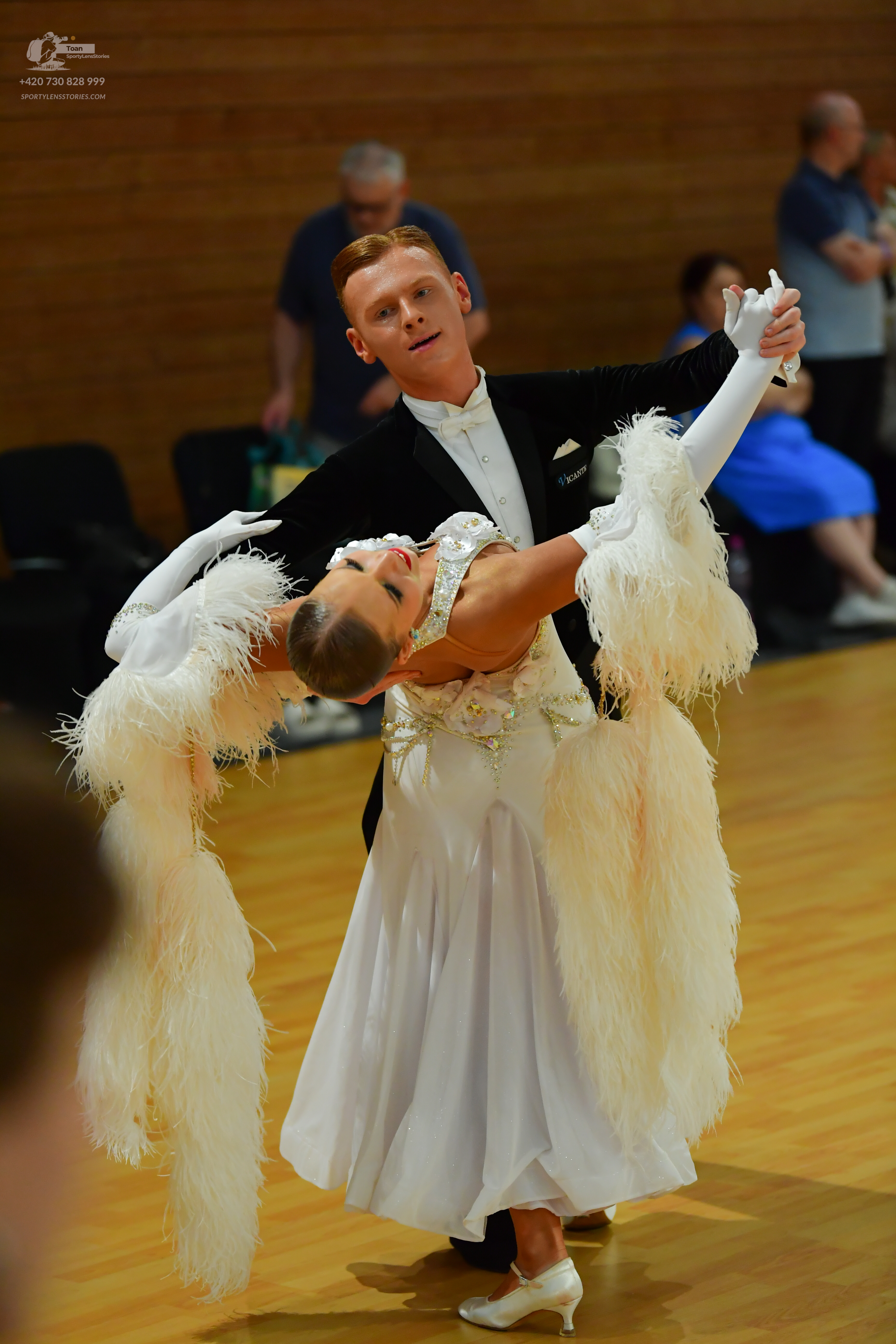 Dancesport competitor: ** Male: Black ballroom suit with white sequin lapels and cuffs