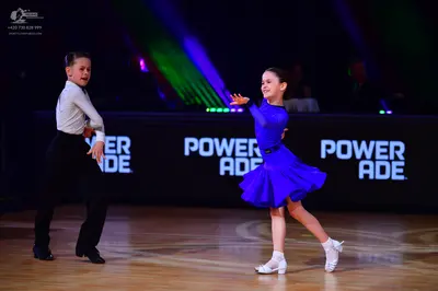 Dancesport competitor: Male dancer: white long-sleeved shirt and black trousers