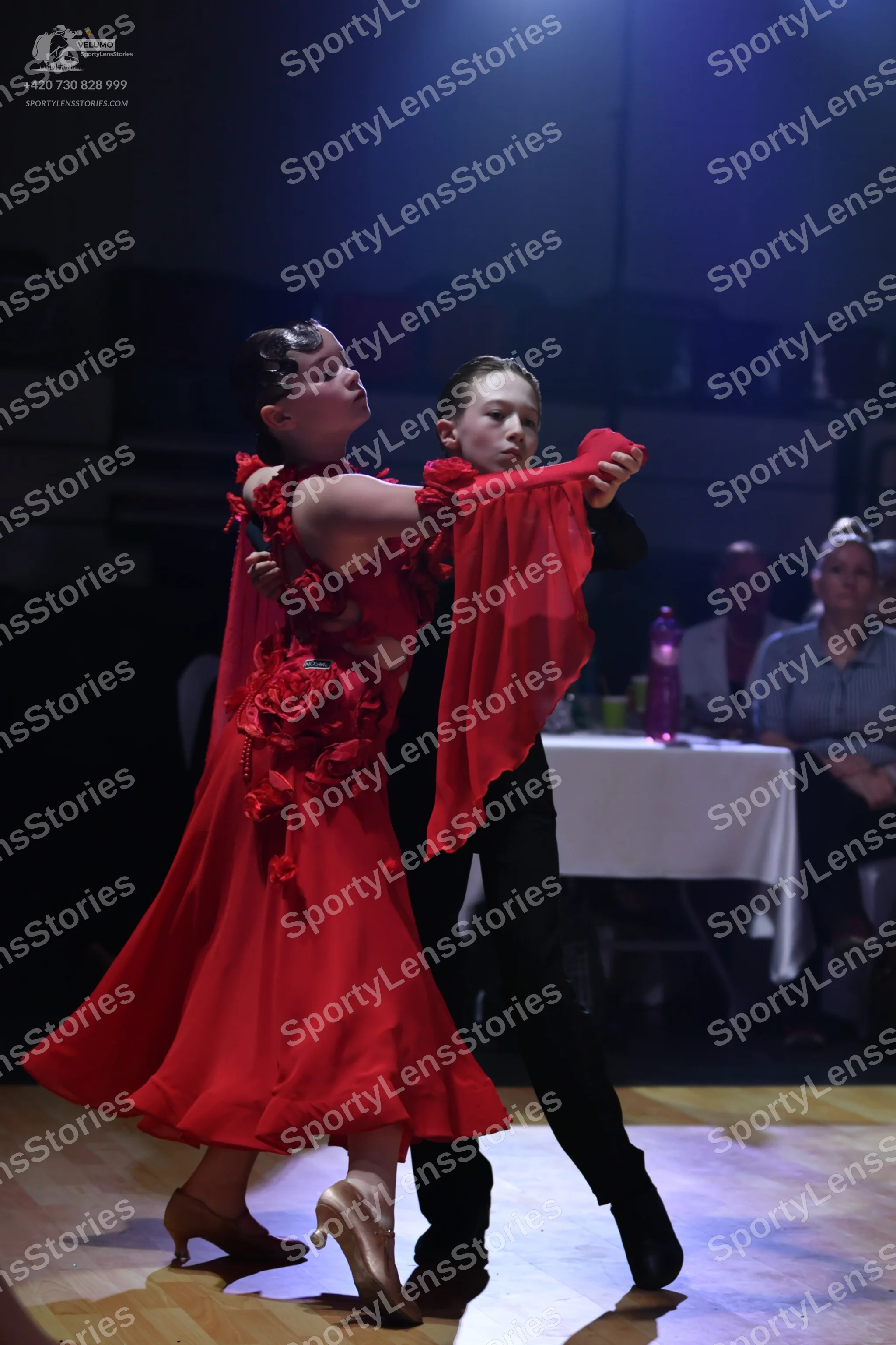 Dancesport competitor: Female dancer: red Latin dress with floral embellishments