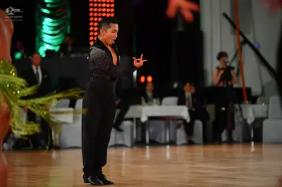 Dancesport competitor: Male dancer: black long-sleeved shirt with subtle shimmer or fine sequins and bl