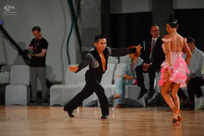 Dancesport competitor: Male dancer: black long-sleeved Latin dance shirt with a large sequined panel on