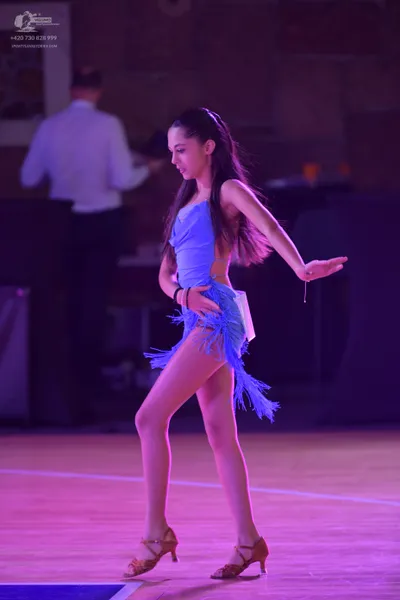 Dancesport competitor: Female dancer: light blue latin dress with long fringe