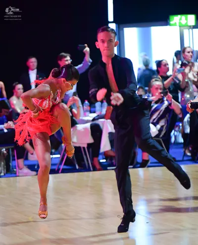 Dancesport competitor: Female dancer: red Latin dress with fringe