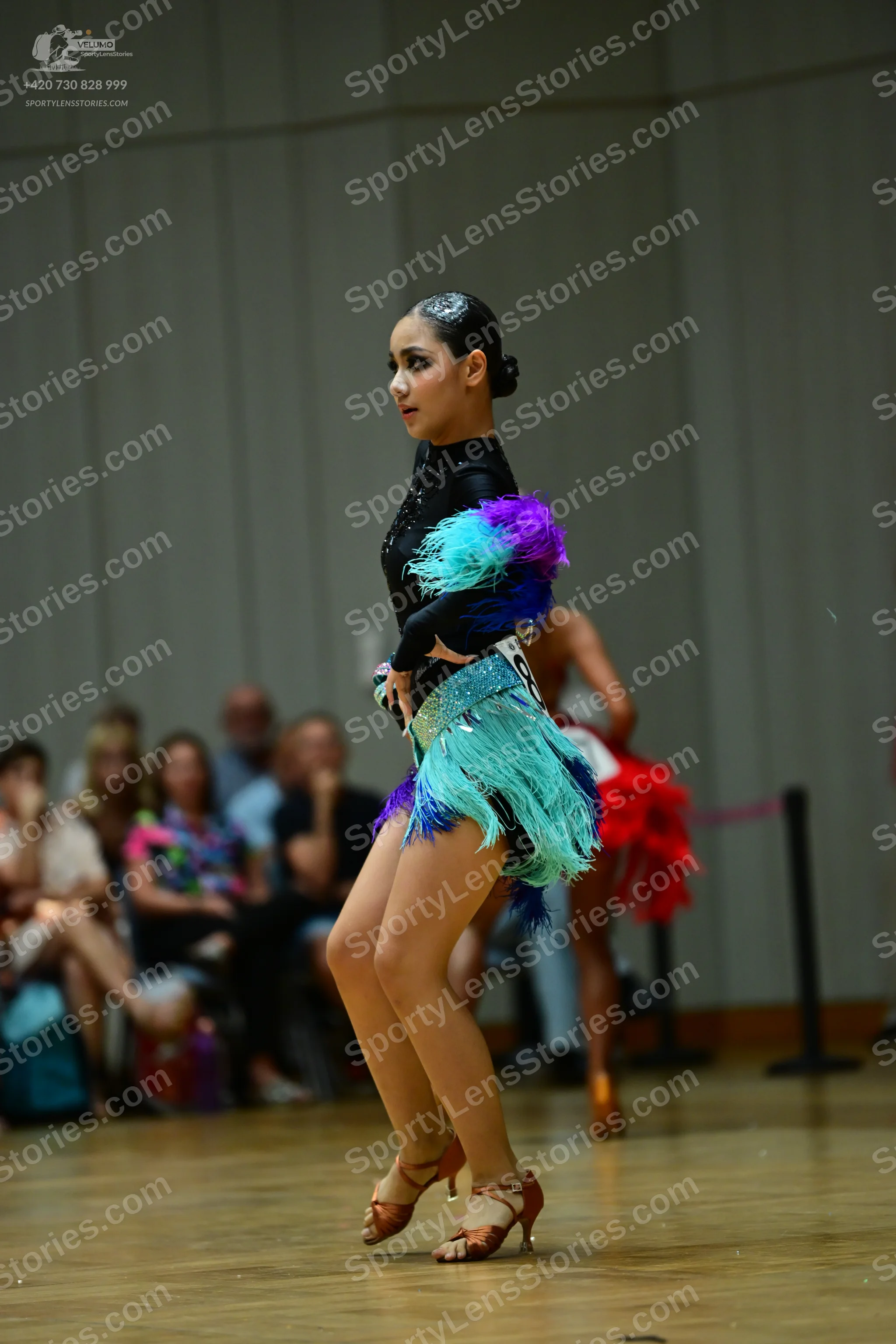 Dancesport competitor: ** Female: Teal/Aqua Latin dress with a dramatic, layered skirt