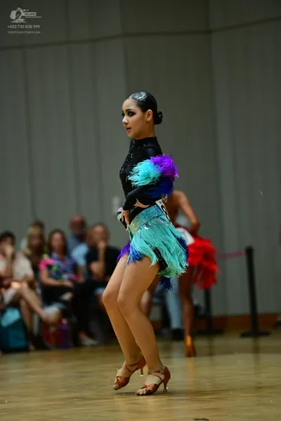 Dancesport competitor: ** Female: Teal/Aqua Latin dress with a dramatic, layered skirt