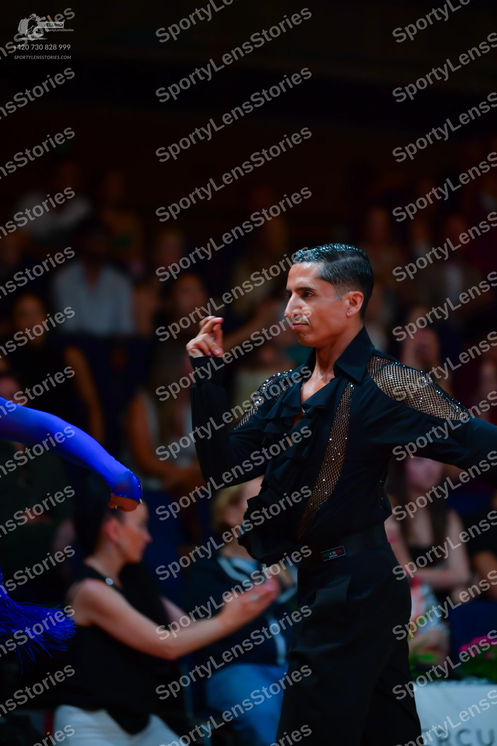 Dancesport competitor: Male dancer: black long-sleeved shirt with sequin detail on the shoulder and bla