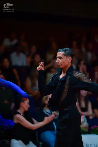 Dancesport competitor: Male dancer: black long-sleeved shirt with sequin detail on the shoulder and bla