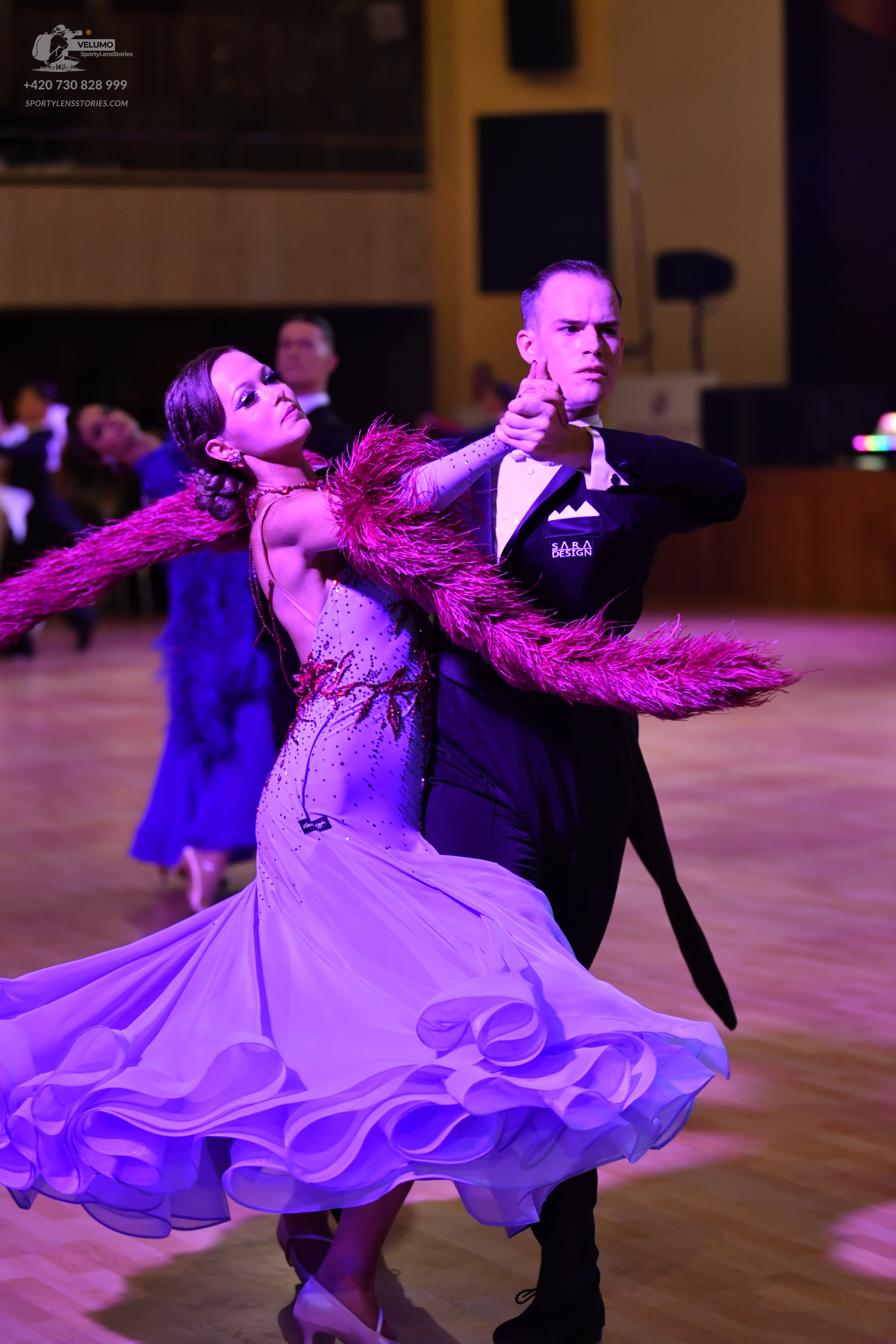 Dancesport competitor: Female dancer: light lavender ballgown with a sequined bodice, voluminous ruffle