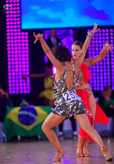 Dancesport competitor #257: Foreground dancer: silver and black sequined Latin dance costume with a backless