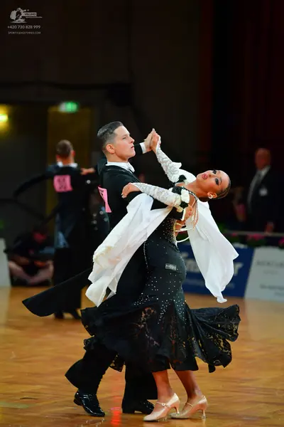 Dancesport competitor: Male dancer: black suit with a white shirt and black trousers