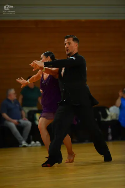 Dancesport competitor: Male dancer: black long-sleeved top and black trousers