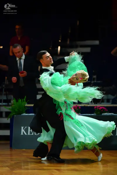Dancesport competitor: Male dancer: black ballroom suit with a white shirt
