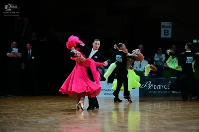 Dancesport competitor #103, #100: Female dancer: bright pink Latin dress with a flared skirt