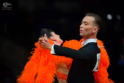 Dancesport competitor: Male dancer: black suit with a white shirt