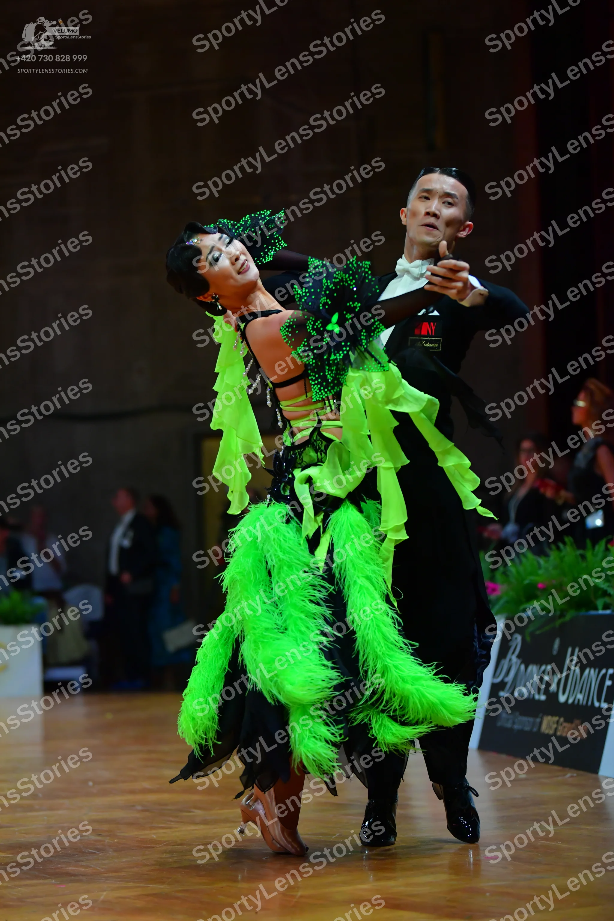 Dancesport competitor: Female dancer: lime green and black Latin dance dress with voluminous lime green