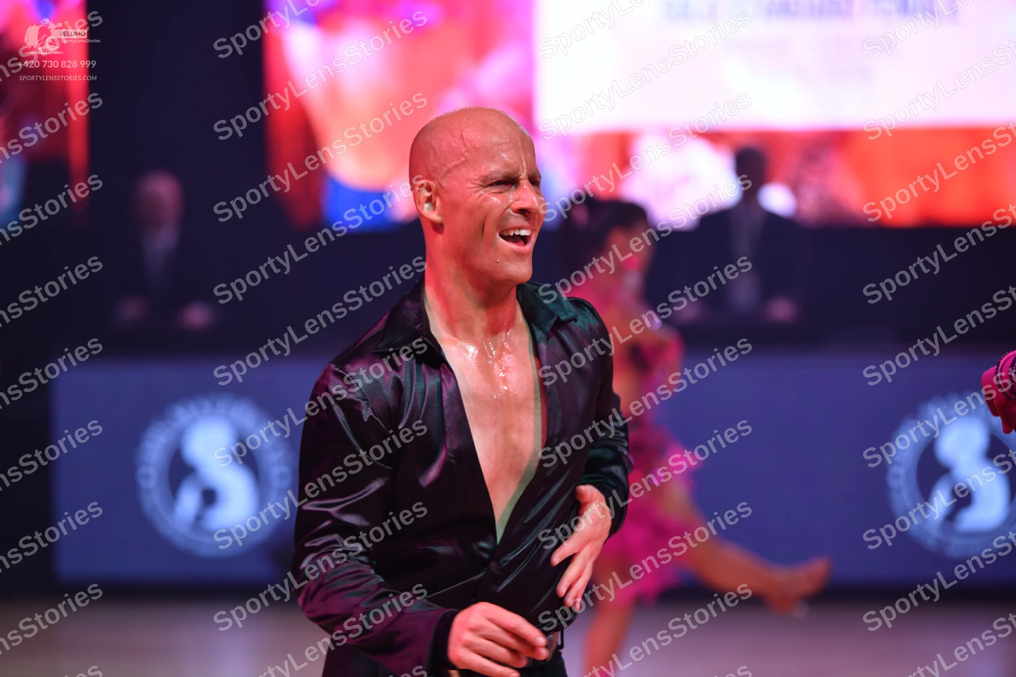 Dancesport competitor: Male dancer: black satin-finish long-sleeved shirt, worn open at the chest