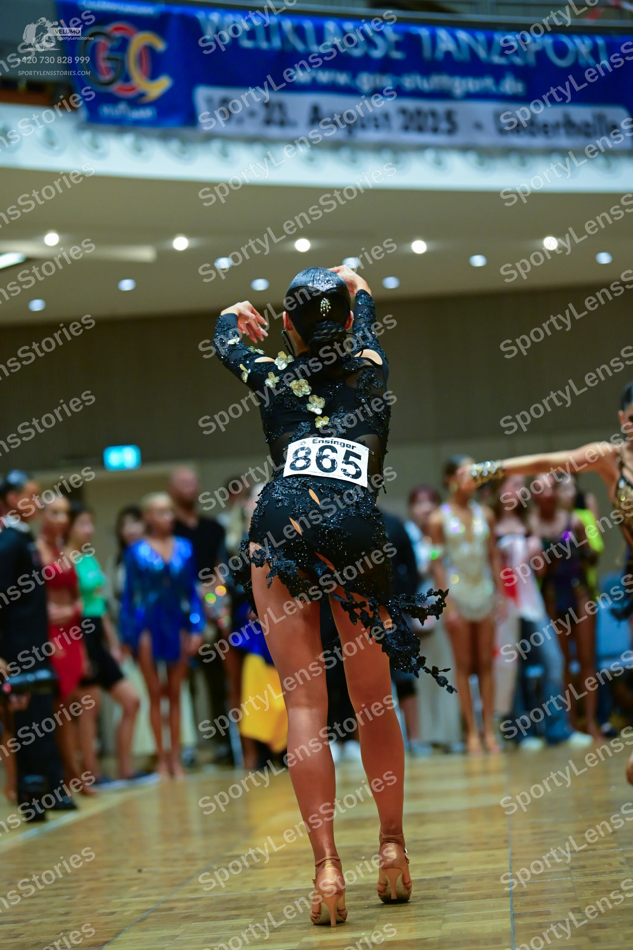 Dancesport competitor #865: Central dancer: black long-sleeved latin dress with lace and sequin embellishmen