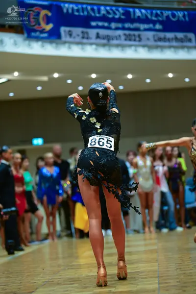 Dancesport competitor #865: Central dancer: black long-sleeved latin dress with lace and sequin embellishmen