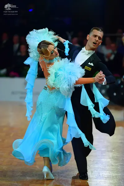 Dancesport competitor: Male dancer: black formal suit with a white shirt and white bow tie