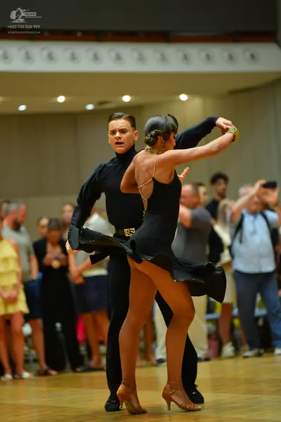 Dancesport competitor: Male dancer: black long-sleeved high-neck top and black trousers