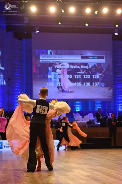 Dancesport competitor: Male dancer: black waistcoat over a white shirt and black trousers