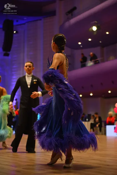 Dancesport competitor: Male dancer: black suit, white shirt, and white bow tie