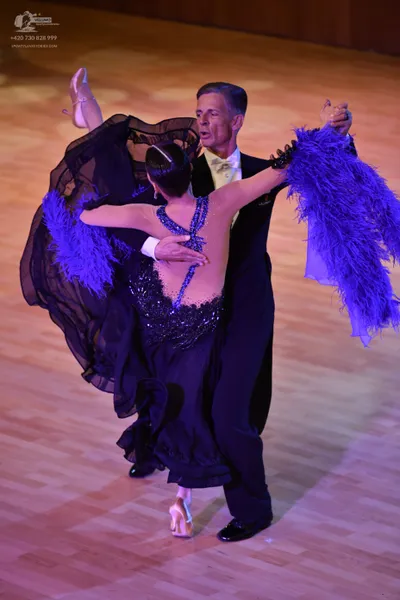 Dancesport competitor: Male:** Black tail suit with silver sequin lapels and a matching bow tie