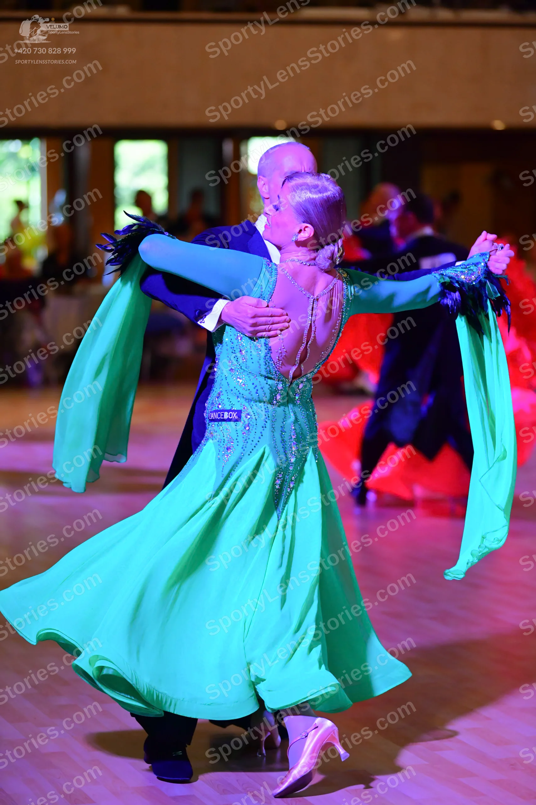 Dancesport competitor: ** Teal/Aqua Latin Dress
*   **Color:** Deep teal with subtle shimmer
*   **Fabr