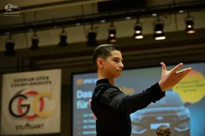 Dancesport competitor: Male dancer: black long-sleeved top
