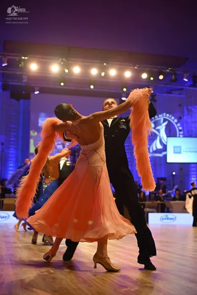 Dancesport competitor: Female dancer: peach ballroom gown with a sequined or lace bodice and a full, fl