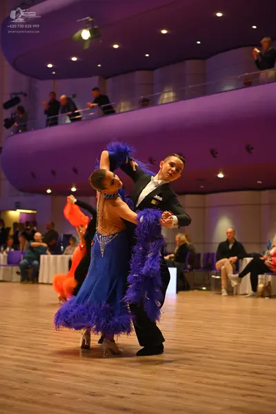 Dancesport competitor: Male dancer: black suit with a white shirt