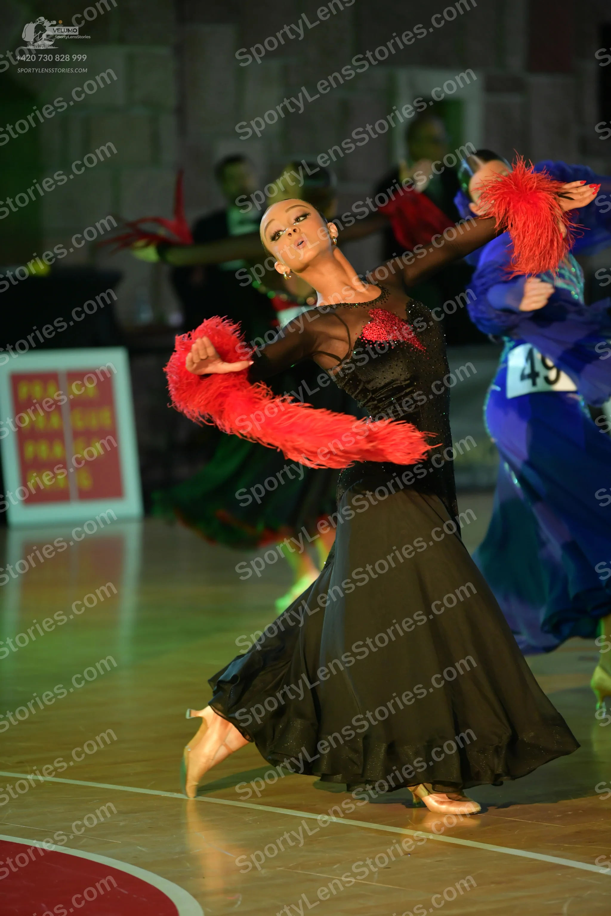 Dancesport competitor #49: Main female dancer: black ballroom gown with a red sequined bodice, sheer black