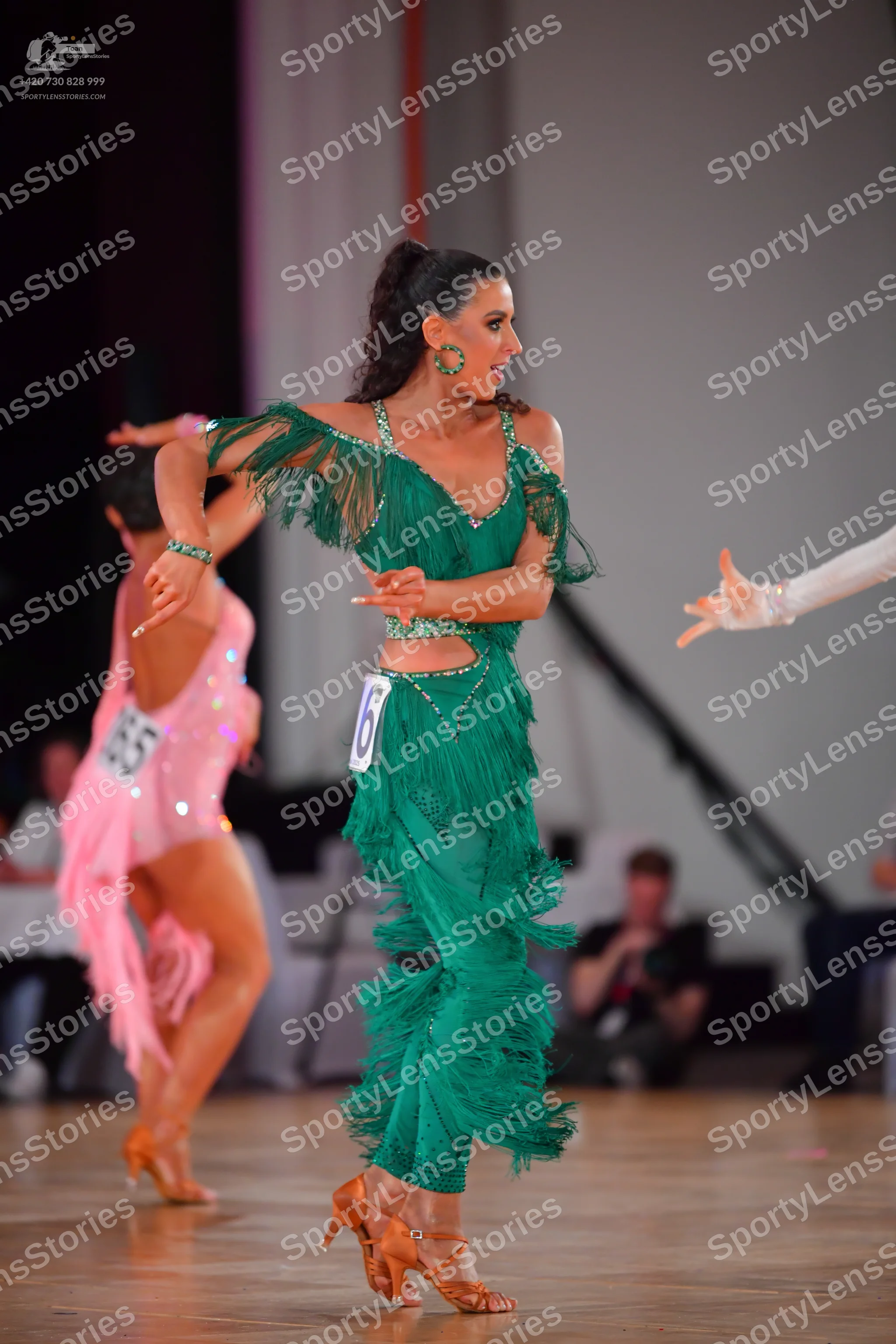 Dancesport competitor #16, #165: Female dancer in green: green latin dress with heavy fringe, sequins, and waist