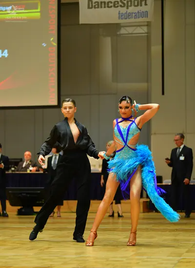 Dancesport competitor: Male dancer: black long-sleeved shirt open at the chest and black trousers