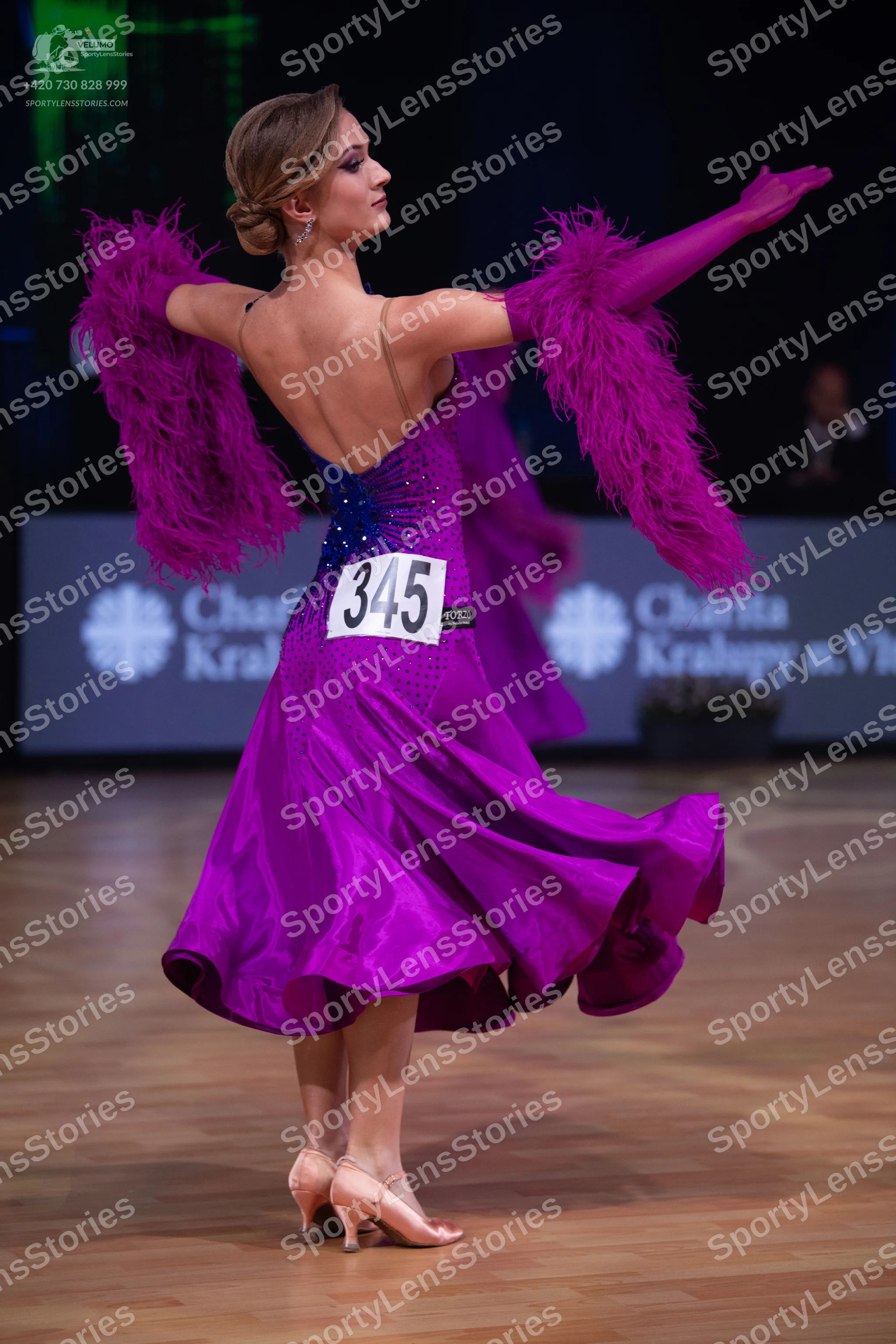 Dancesport competitor: Female dancer: purple satin ballroom dress with sequin embellishments on the bod