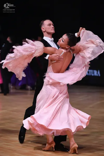 Dancesport competitor: Male dancer: black suit with a white shirt and white bowtie