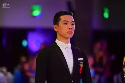 Dancesport competitor: Male dancer: black suit, white shirt, and white bow tie