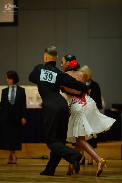 Dancesport competitor: Male dancer: black long-sleeved shirt and black trousers