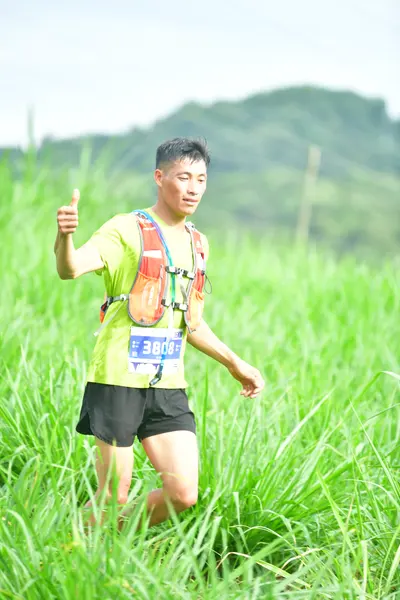 Marathon runner: Runner 1: lime green jersey, black shorts, hydration pack