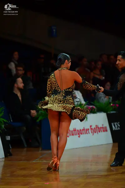 Dancesport competitor: Female dancer: leopard print latin dress with black lace detailing and a backles