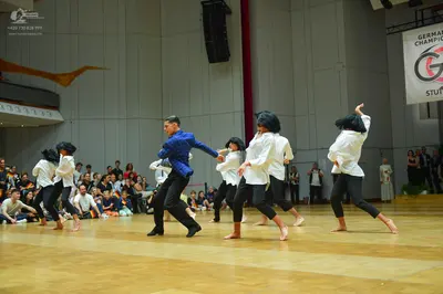 Dancesport competitor: Male dancer: blue long-sleeved shirt and black trousers