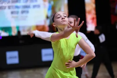 Dancesport competitor: Female dancer: lime green short-sleeved latin dress