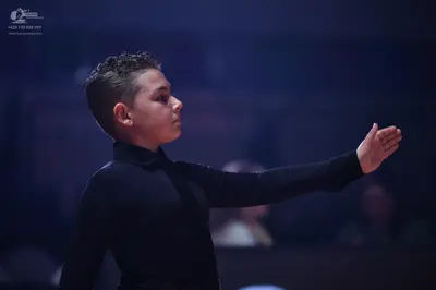 Dancesport competitor: Male dancer: black long-sleeved tight-fitting top