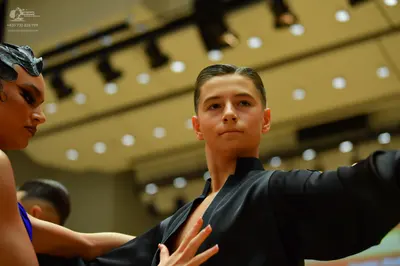 Dancesport competitor: Male dancer: black long-sleeved top
