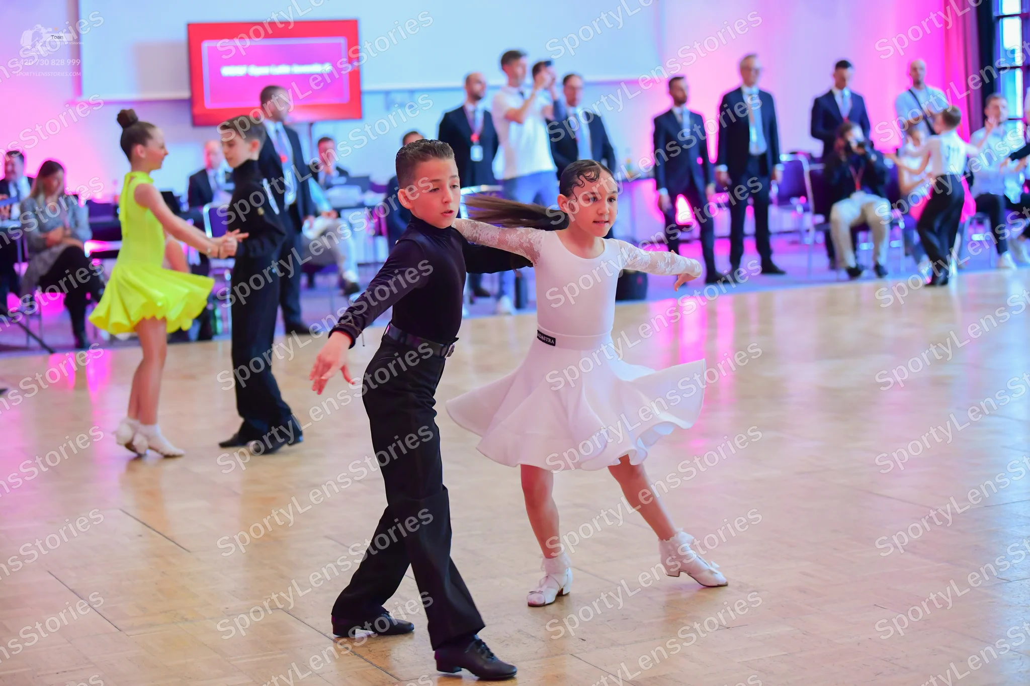 Dancesport competitor: Female dancer: yellow latin dress with a flared skirt
