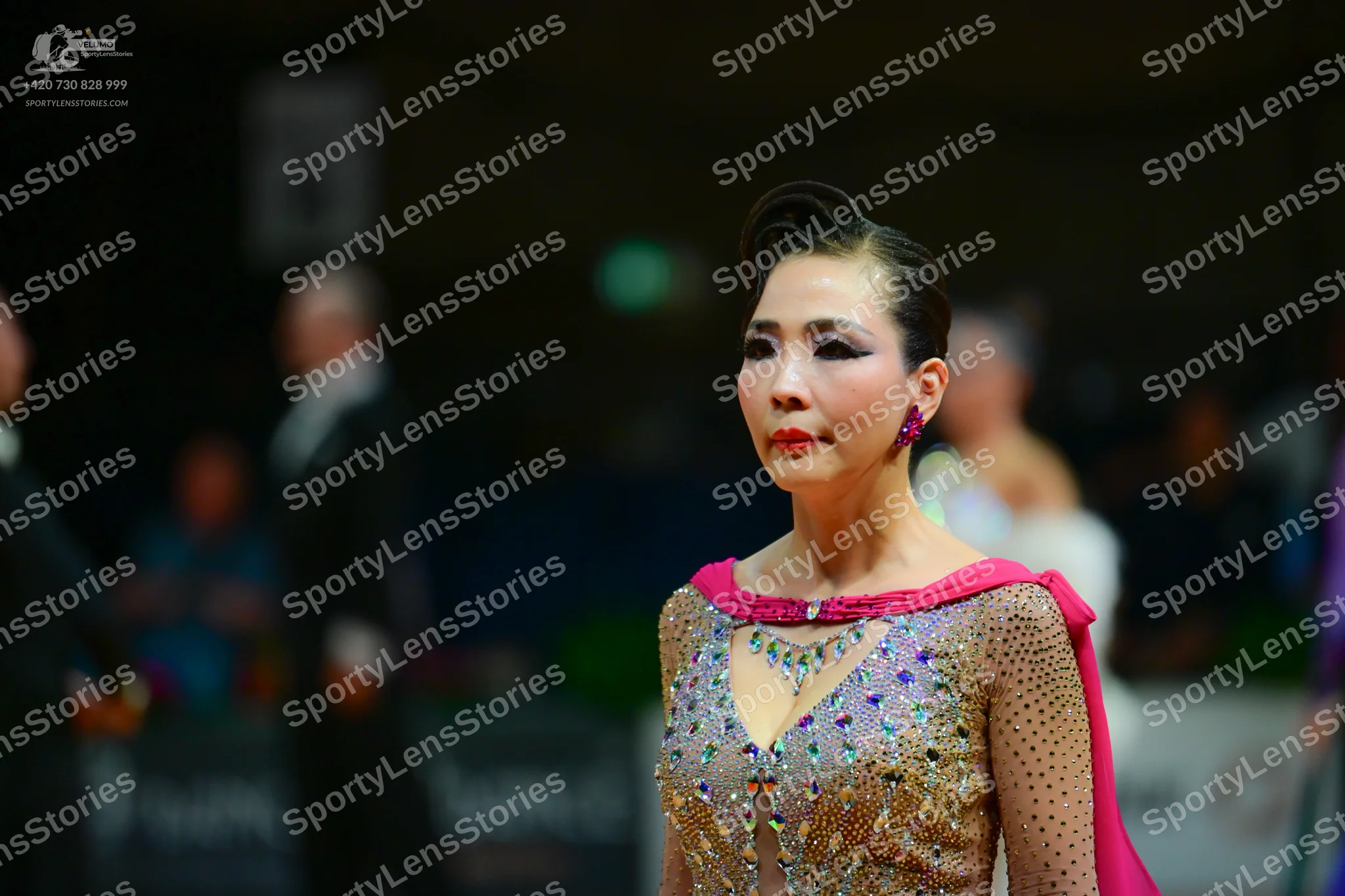 Dancesport competitor: Female dancer: nude-colored dress heavily embellished with rhinestones and cryst