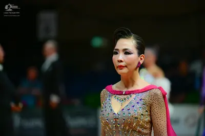 Dancesport competitor: Female dancer: nude-colored dress heavily embellished with rhinestones and cryst