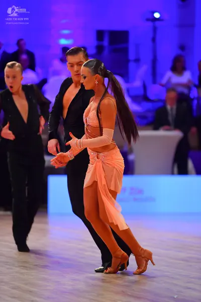 Dancesport competitor: Male dancers: black dance suits with deep V-neck tops and black trousers