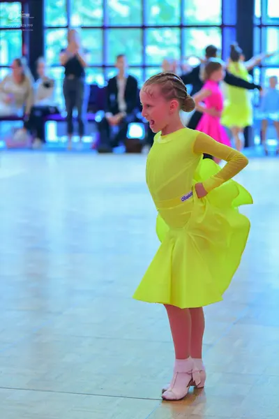 Dancesport competitor: Main dancer: neon yellow long-sleeved dress with a flared skirt